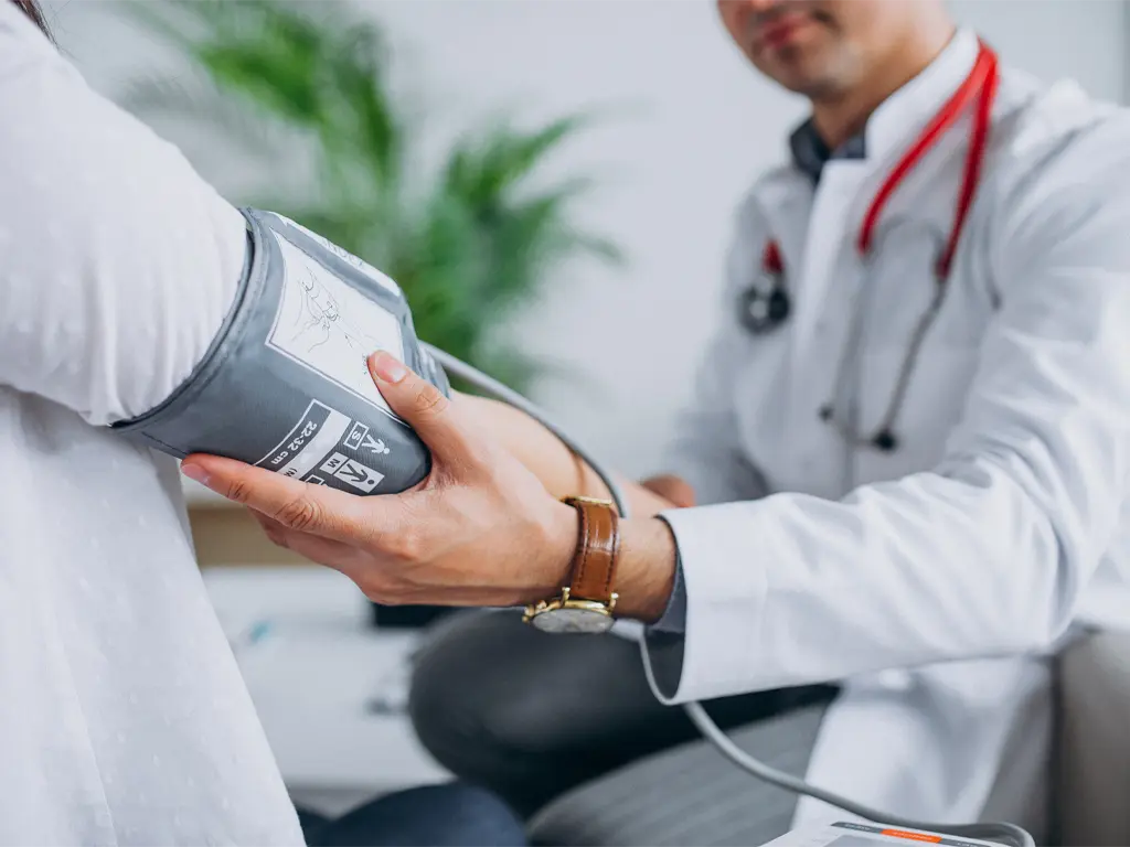 Doctor performs blood pressure test
